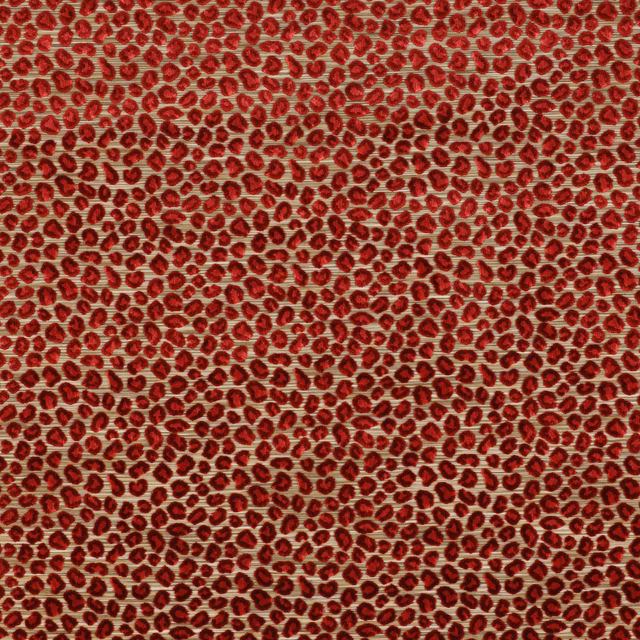 Close-up of small ruby red animal spots on a warm pale woven ground