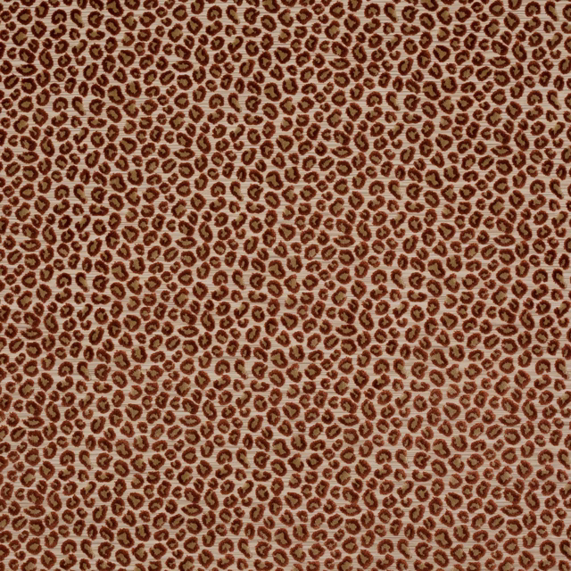 Close-up of small russet leopard spots on a pale cream-beige fabric ground
