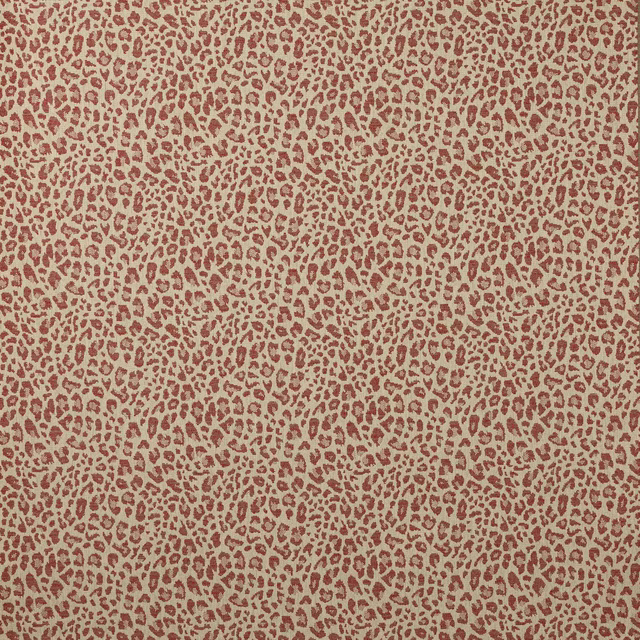 Close-up of small brick-red leopard spots on a sandy woven ground