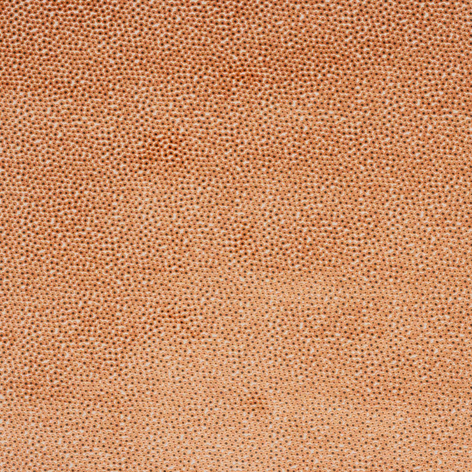 Close-up of textured terracotta-orange fabric with tiny dotted weave