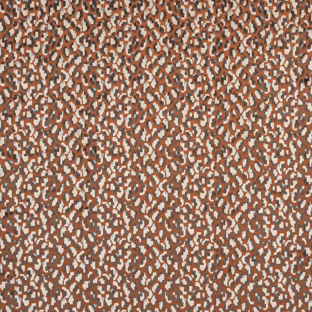 Abstract small-scale terracotta and ivory spotted fabric on a warm brown ground