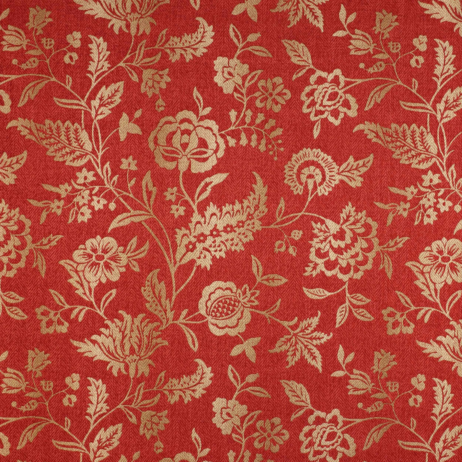 Close-up of a red floral woven fabric with pale gold trailing motifs