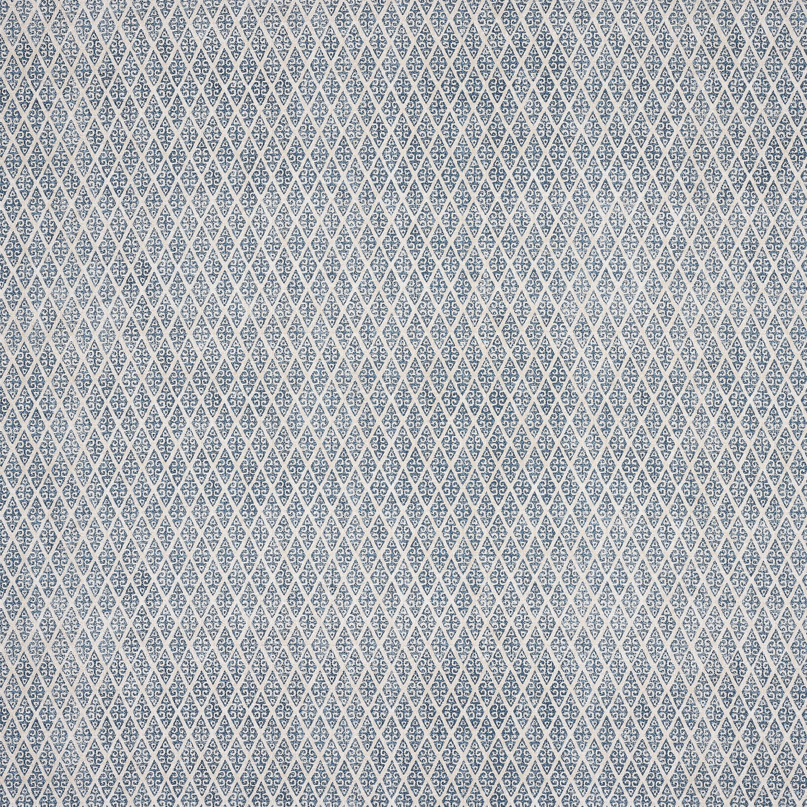 Small indigo blue geometric print on a pale ground, tightly repeating across the swatch