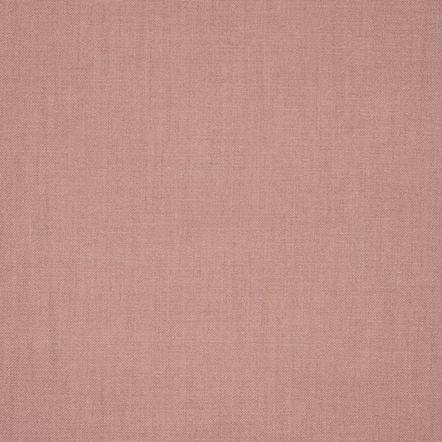 Close-up of plain woven dusty rose pink fabric with a fine matte texture