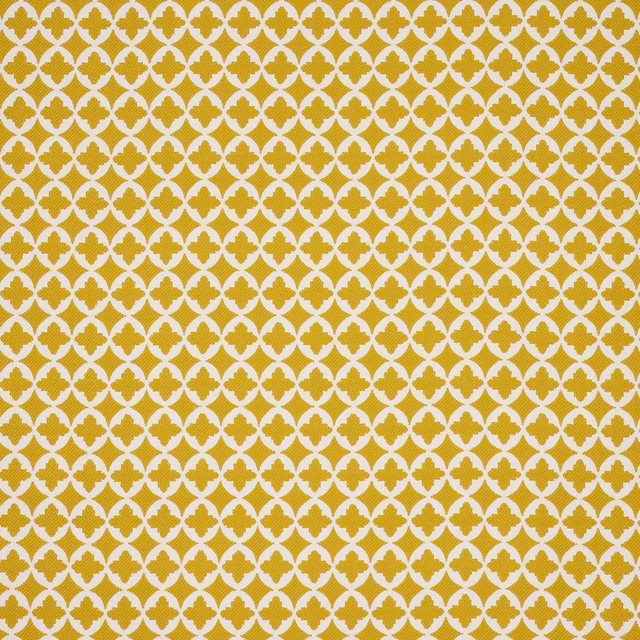 Mustard-gold geometric fabric with a small repeating quatrefoil motif on an off-white ground