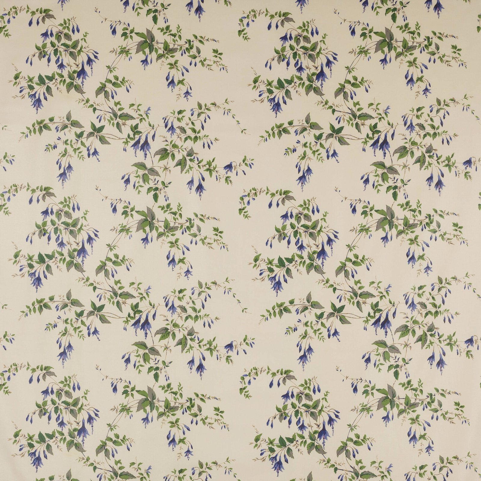 Cream cotton fabric with scattered blue flowers and green leafy trailing sprigs