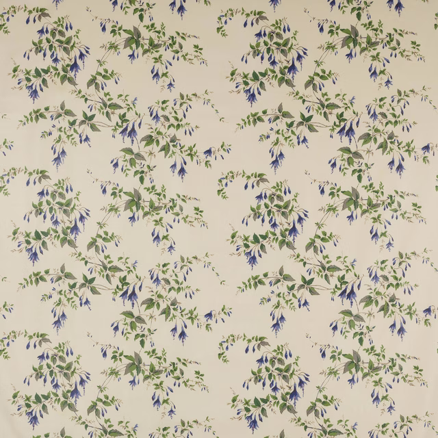 Cream cotton fabric with scattered blue flowers and green leafy trailing sprigs