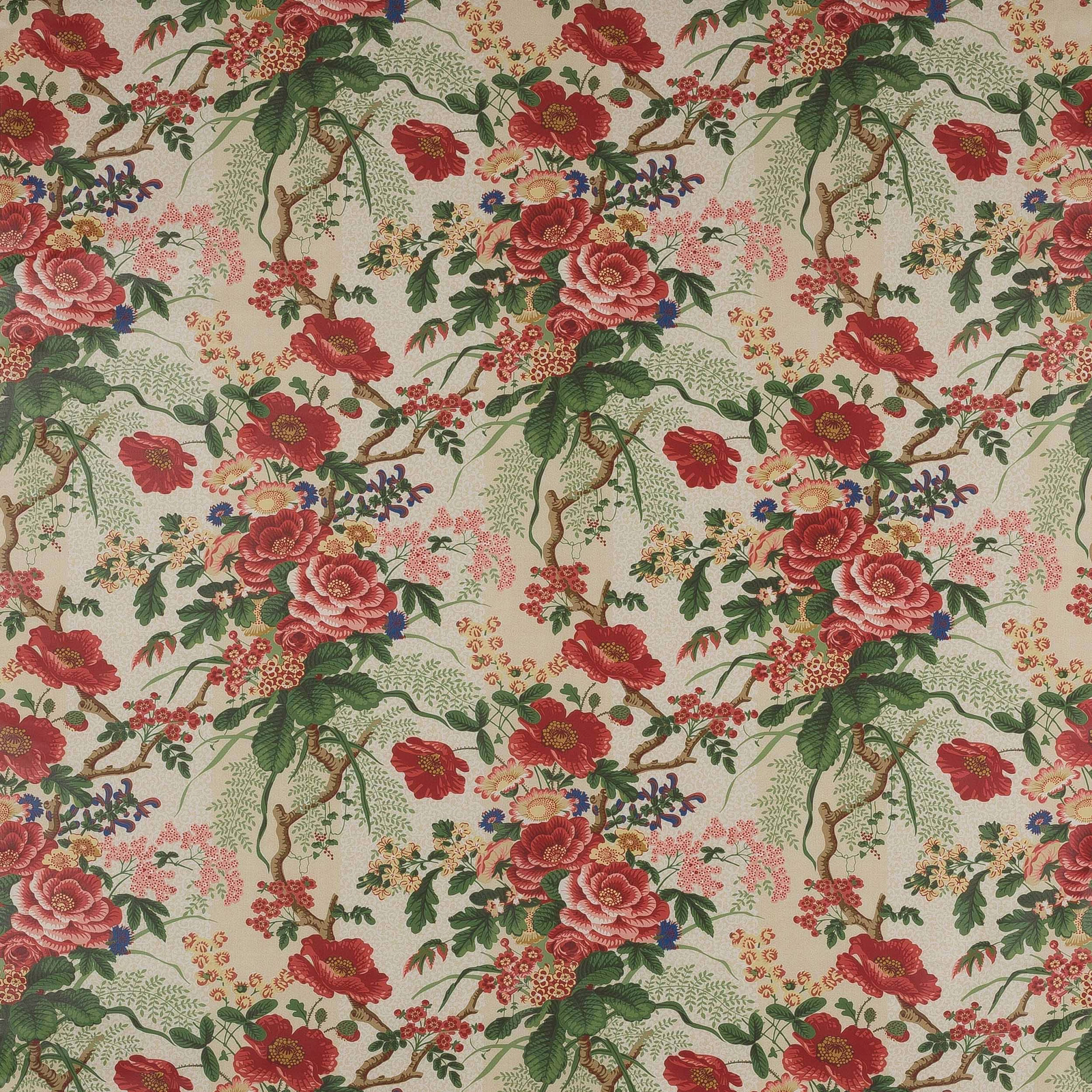 Red and pink floral cotton with green leafy branches on a cream ground