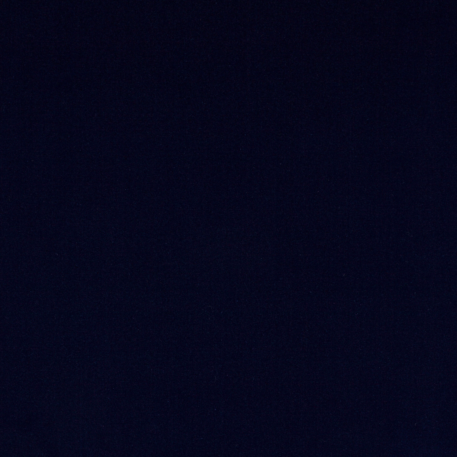 Close-up of deep midnight blue velvet with a smooth, plain pile