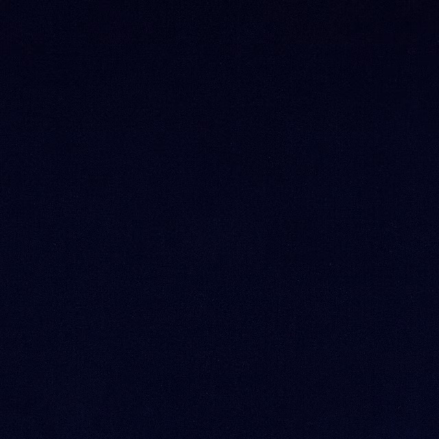 Close-up of deep midnight blue velvet with a smooth, plain pile