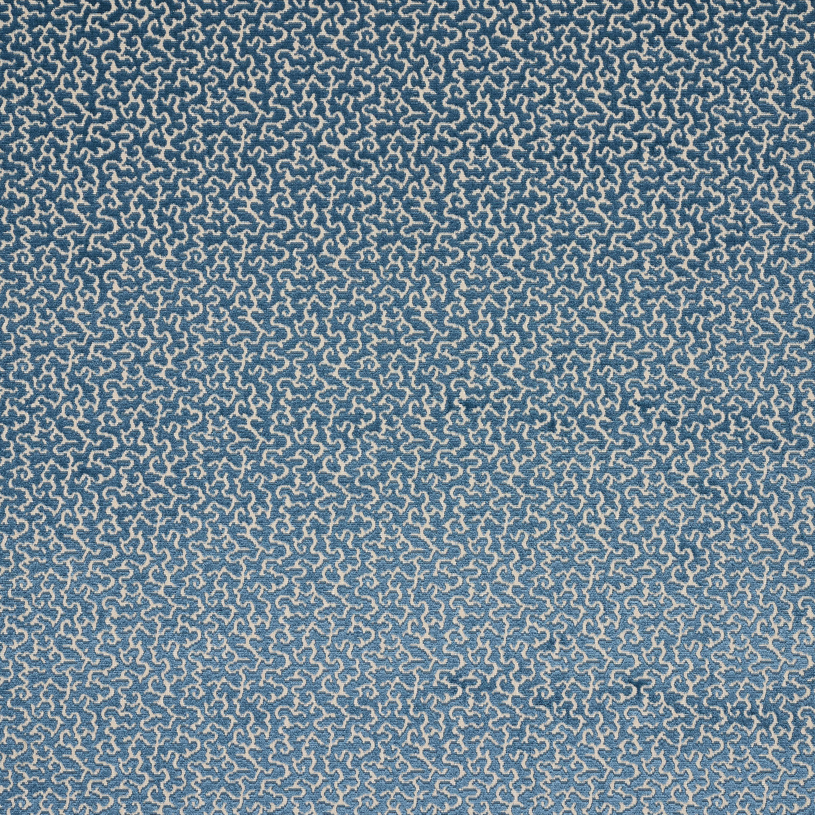 Blue and pale damask-patterned fabric swatch with a textured woven surface