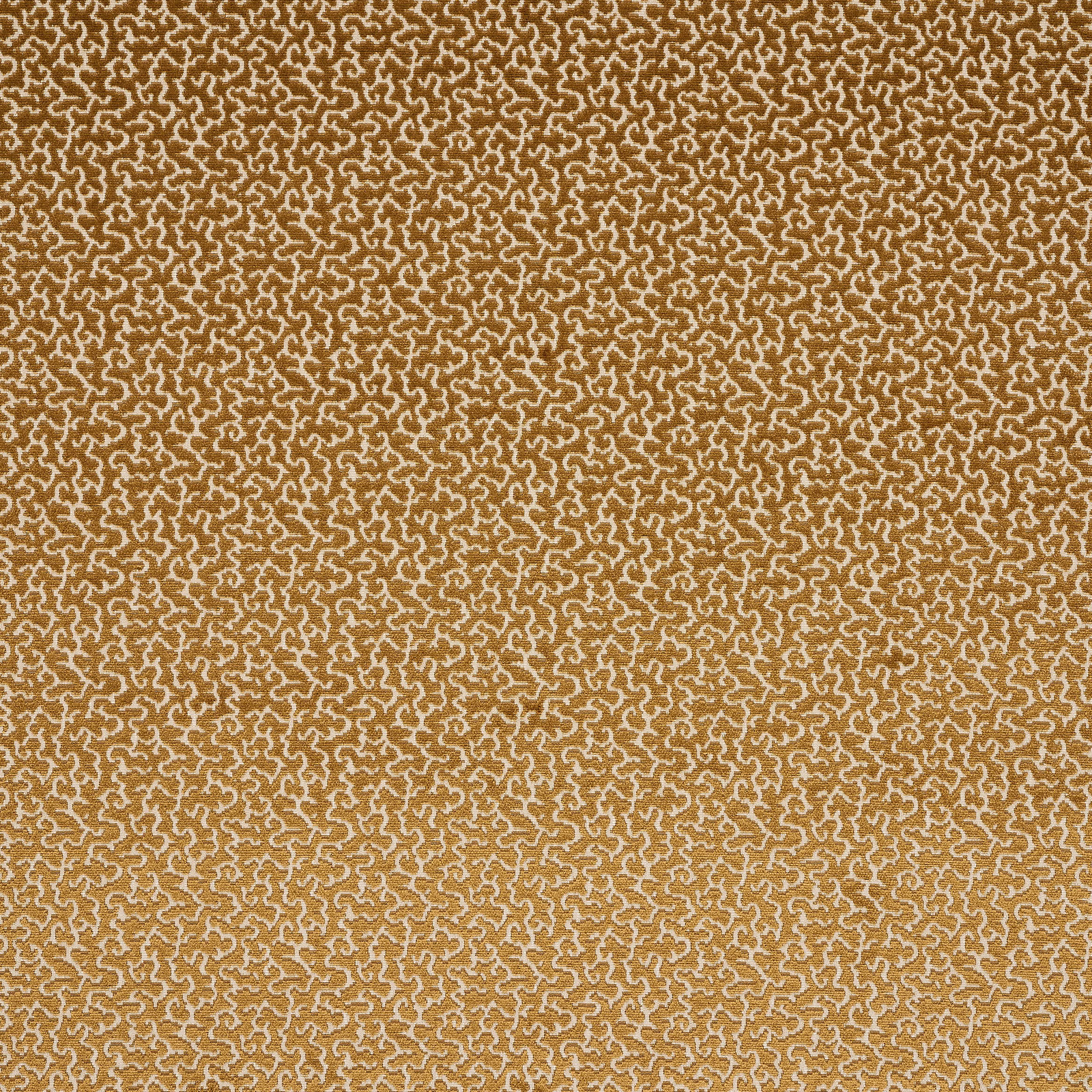 Close-up of ochre-gold woven fabric with small ivory scroll pattern