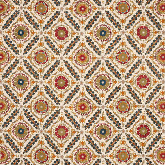 Decorative woven fabric with red, sienna, blue and gold medallions on an ivory ground
