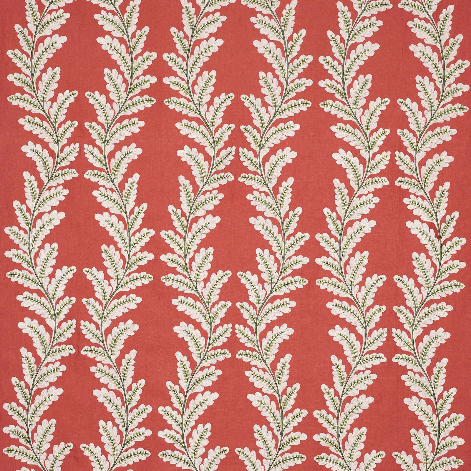Coral-red botanical fabric with cream and olive trailing leaf motif