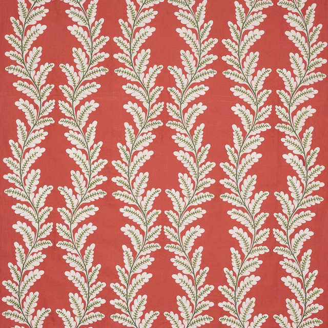 Coral-red botanical fabric with cream and olive trailing leaf motif