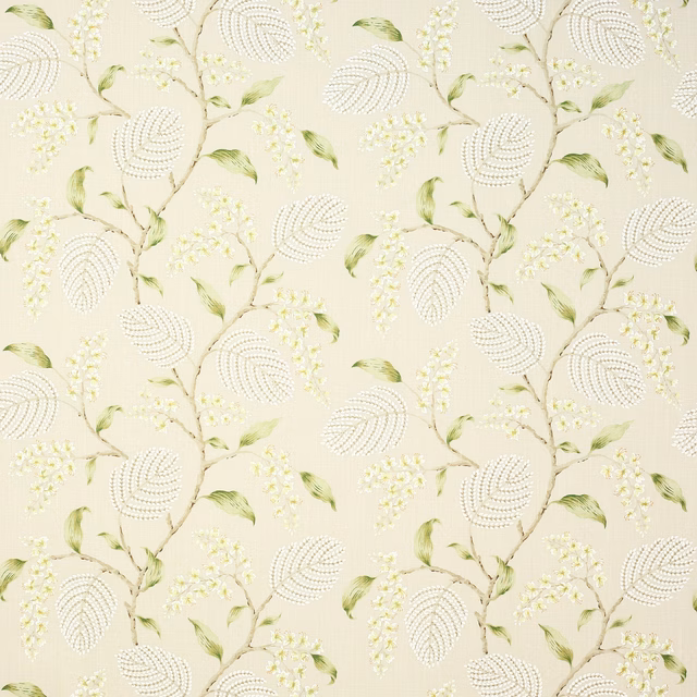 Cream linen fabric with embroidered-style green leaves and tiny blossom sprays