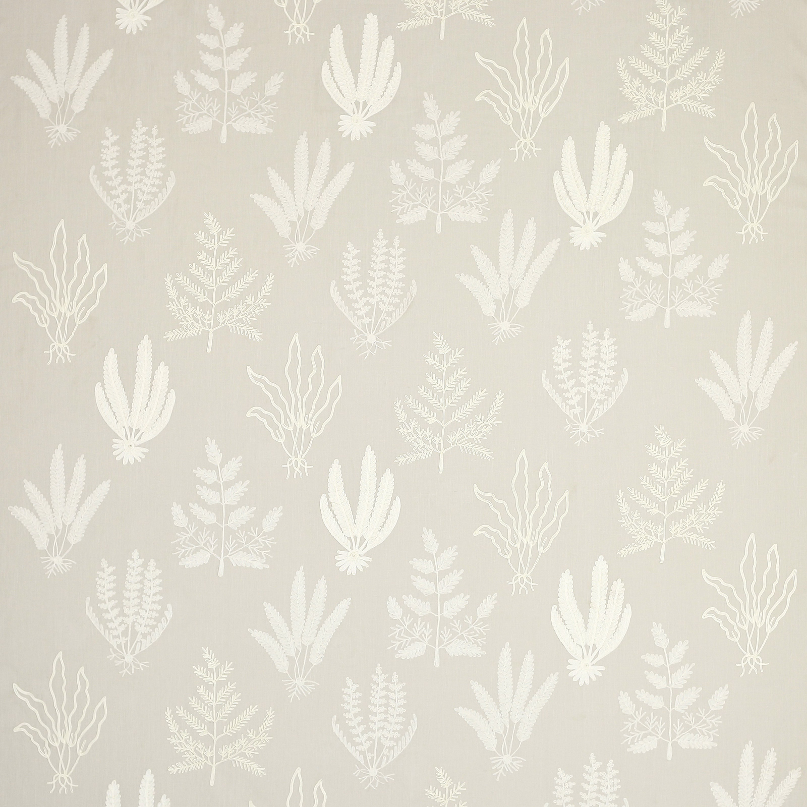 Soft beige fabric with pale ivory botanical leaf motif