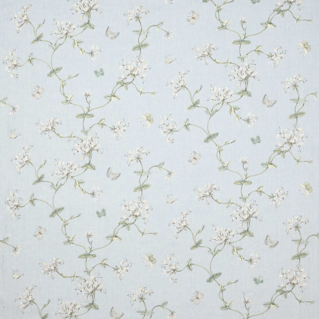 Pale old blue floral fabric with green trailing vines and white blossoms