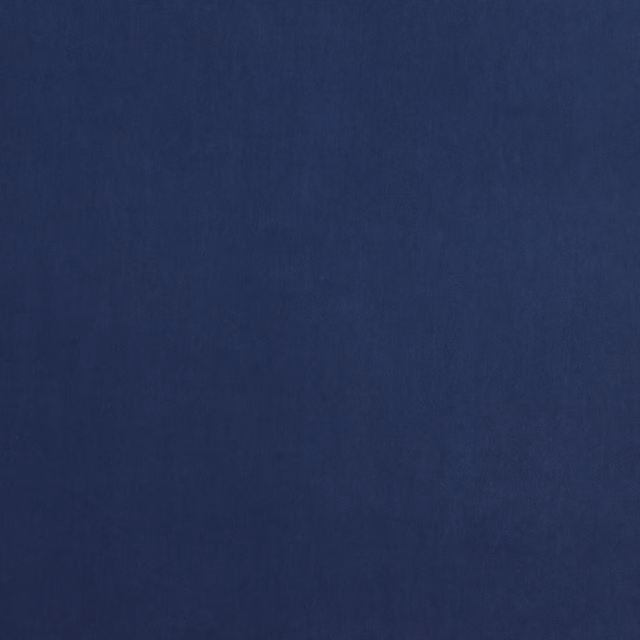 Solid deep indigo blue fabric with a fine, smooth weave