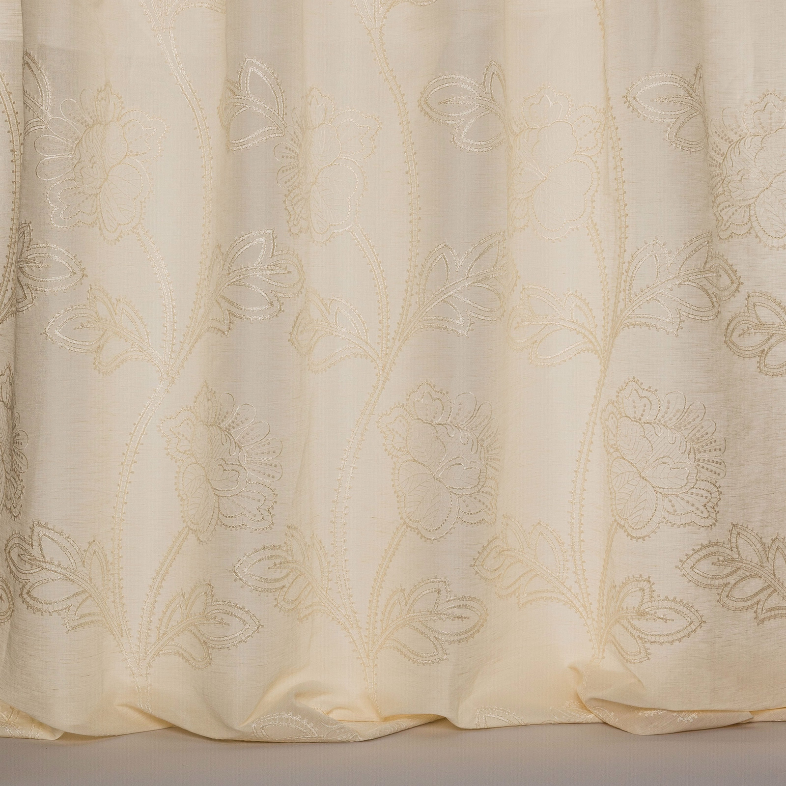 Soft ivory sheer fabric with large floral embroidery and a subtle woven sheen