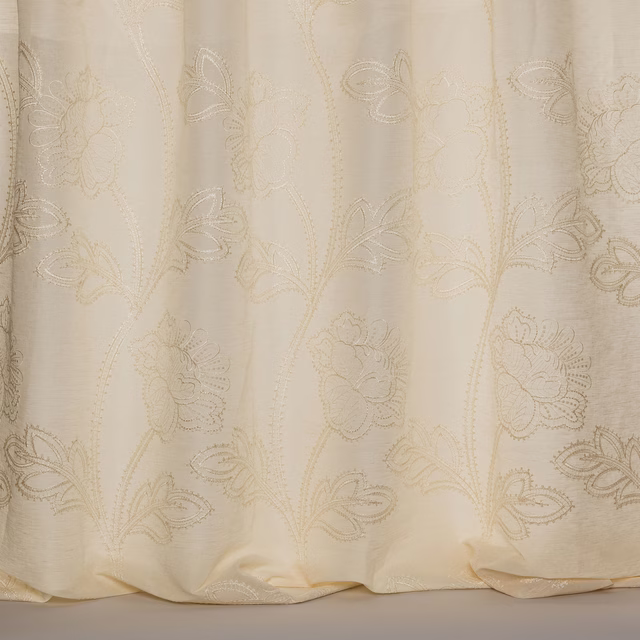Soft ivory sheer fabric with large floral embroidery and a subtle woven sheen