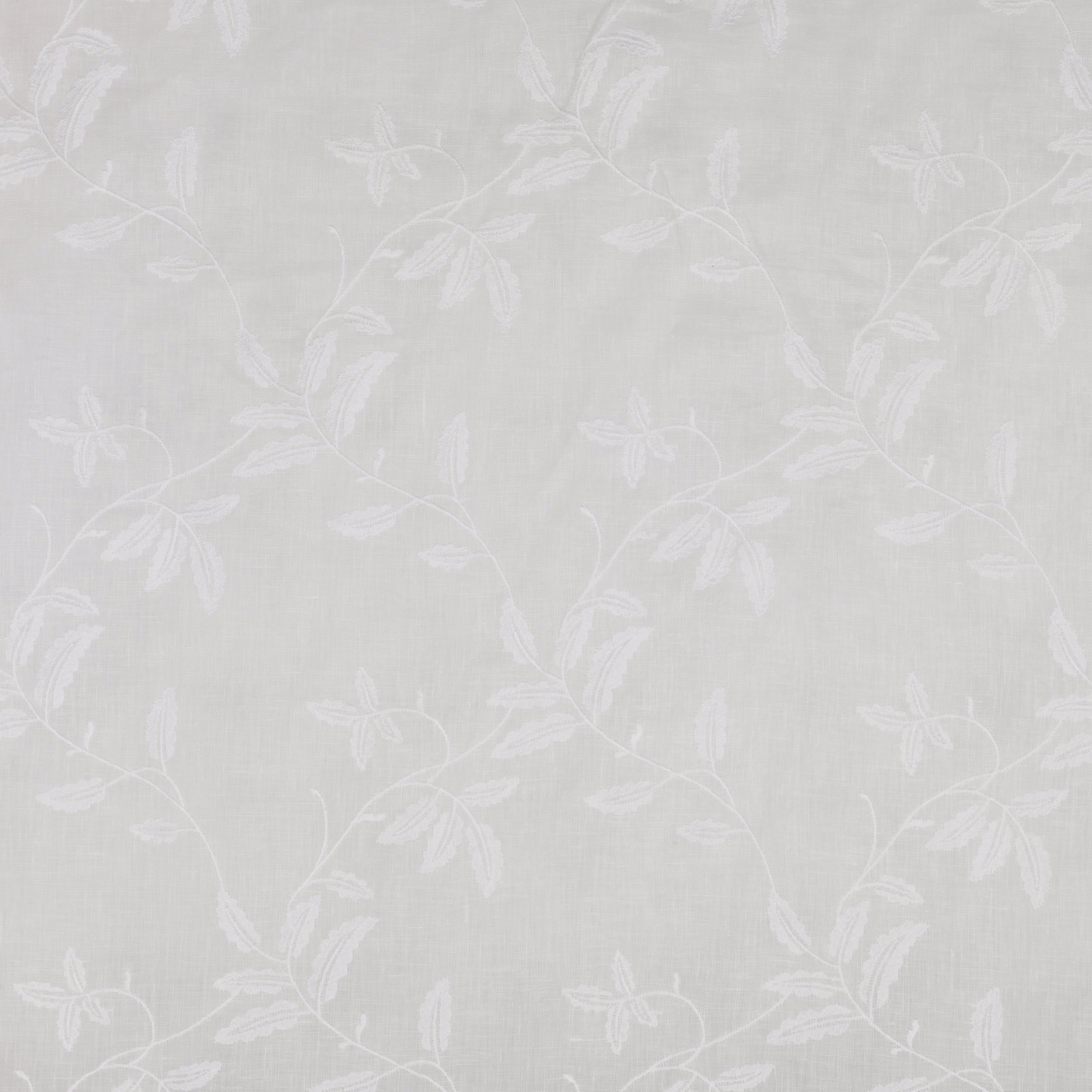 Ivory sheer fabric with subtle embroidered leafy vine pattern