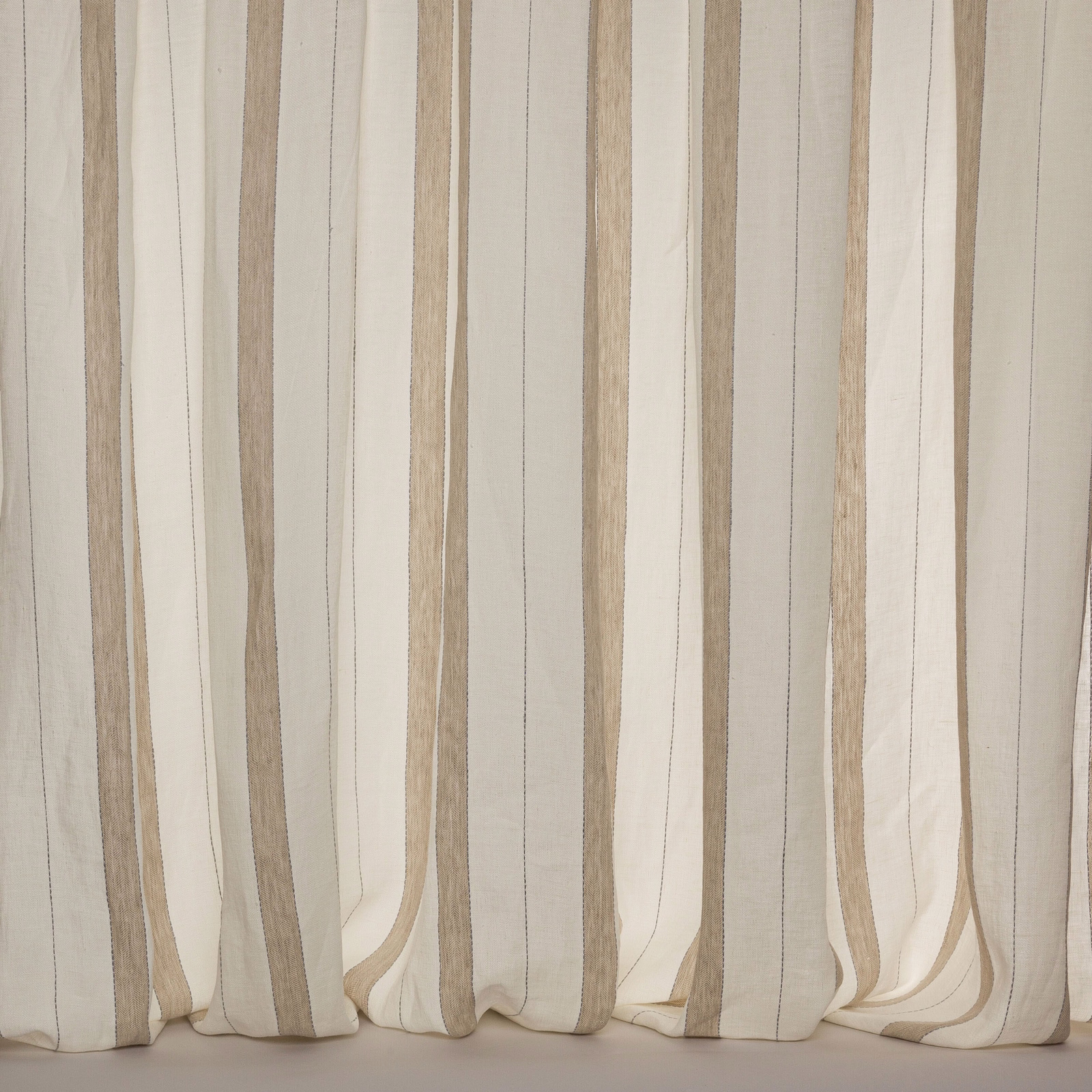 Cream linen sheer curtain with wide vertical beige stripes hanging softly