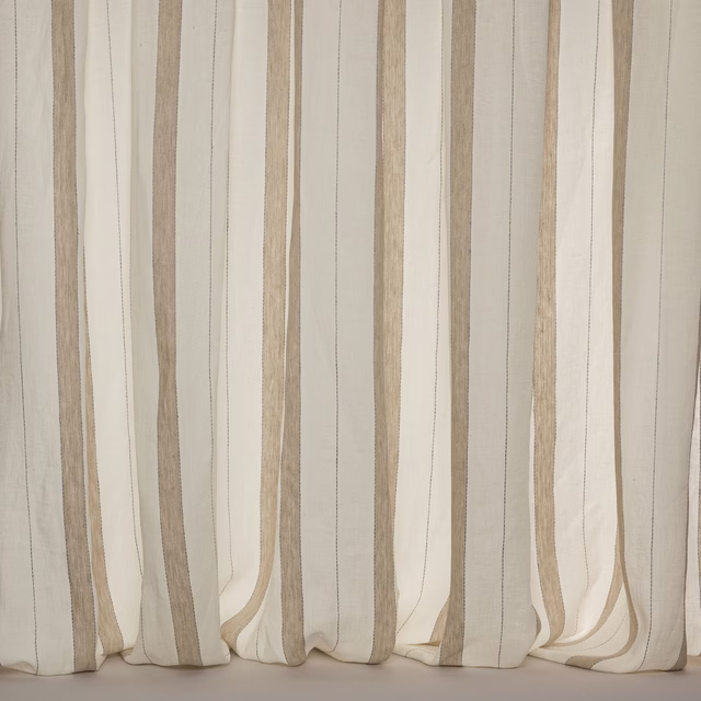 Cream linen sheer curtain with wide vertical beige stripes hanging softly