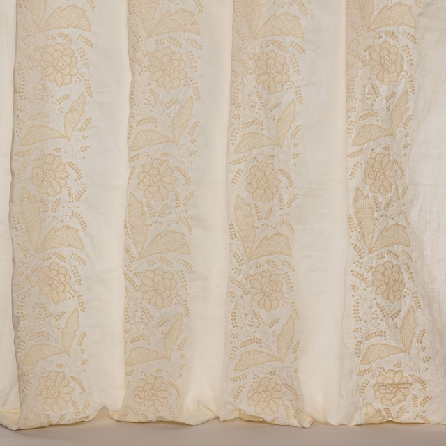 Ivory sheer fabric with vertical floral embroidered stripes and soft cream texture