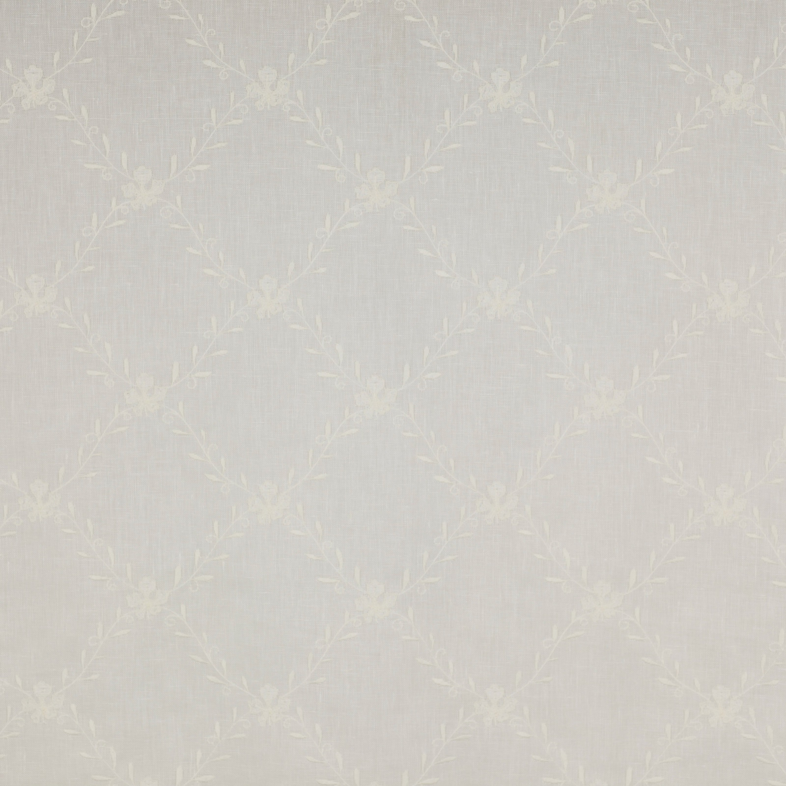 Pale ivory sheer fabric with a subtle floral trellis and leaf motif