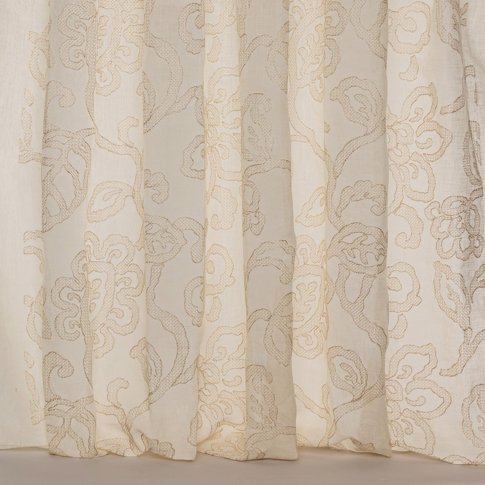 Creamy beige sheer fabric with large scrolling damask pattern
