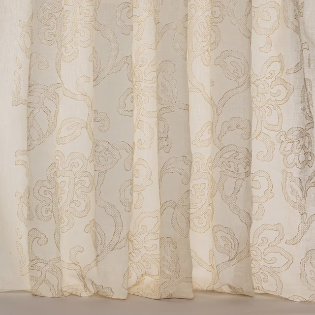 Creamy beige sheer fabric with large scrolling damask pattern