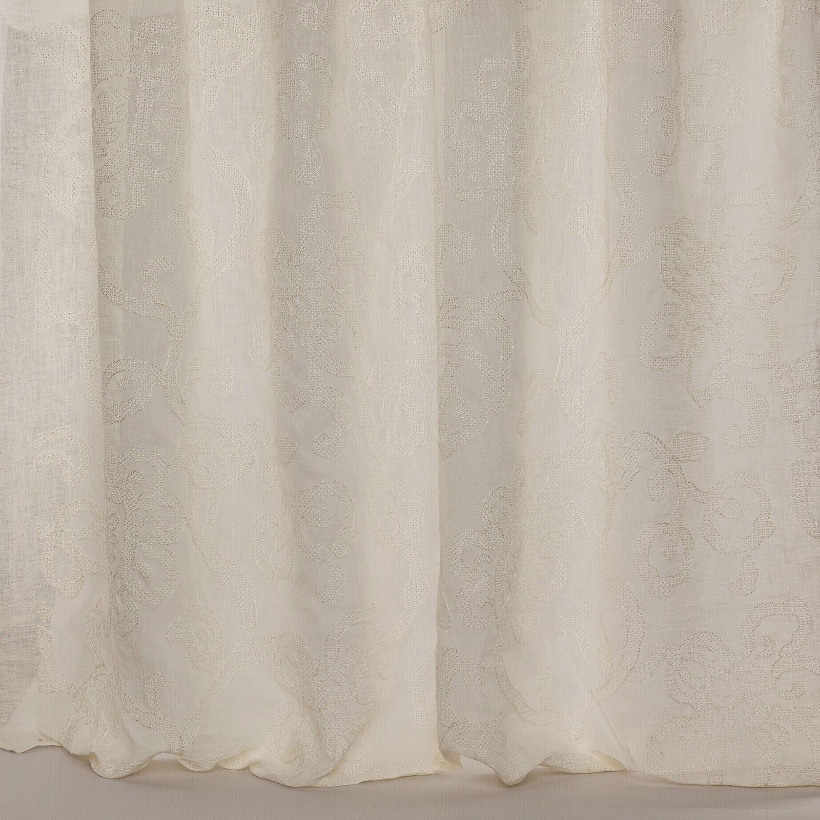 Pale ivory sheer fabric with subtle woven floral pattern and soft texture
