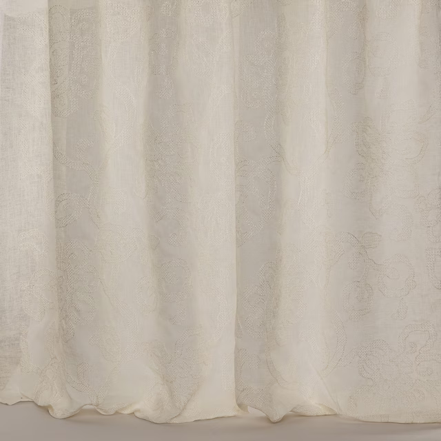 Pale ivory sheer fabric with subtle woven floral pattern and soft texture