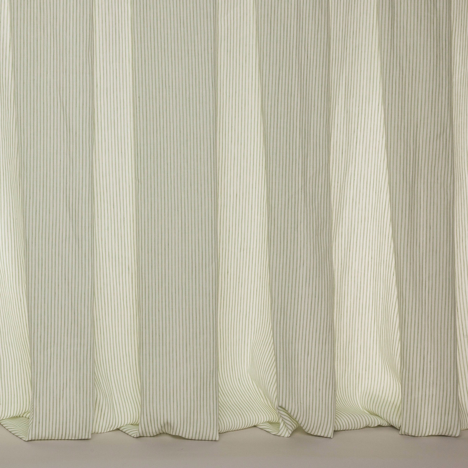 Soft ivory sheer fabric with fine vertical pinstripes and gentle folds
