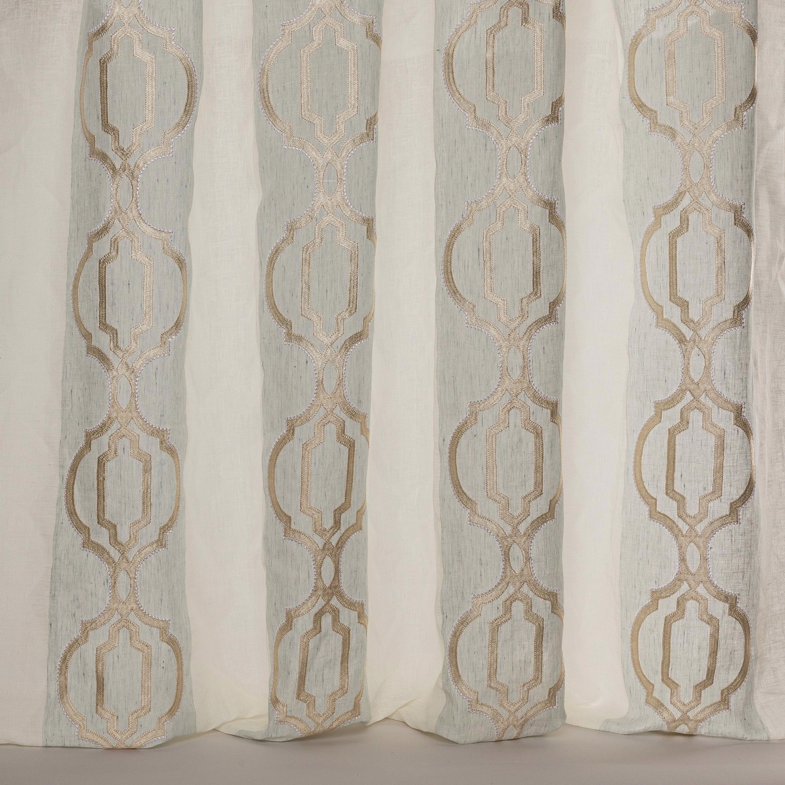 Sheer aqua fabric with vertical geometric motif in warm taupe embroidery