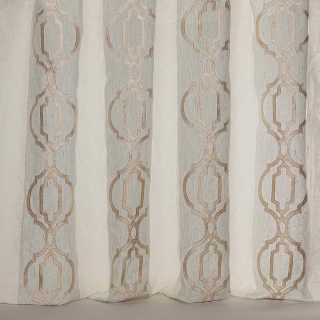 Sheer aqua fabric with vertical geometric motif in warm taupe embroidery