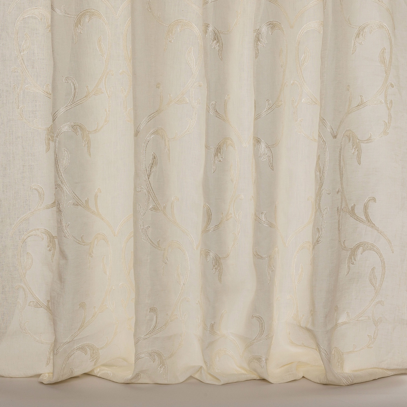 Ivory sheer fabric with pale scrolling embroidery and soft linen texture
