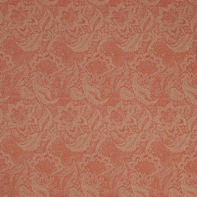 Coral-red damask fabric with ornate woven scrolling motif on a textured ground