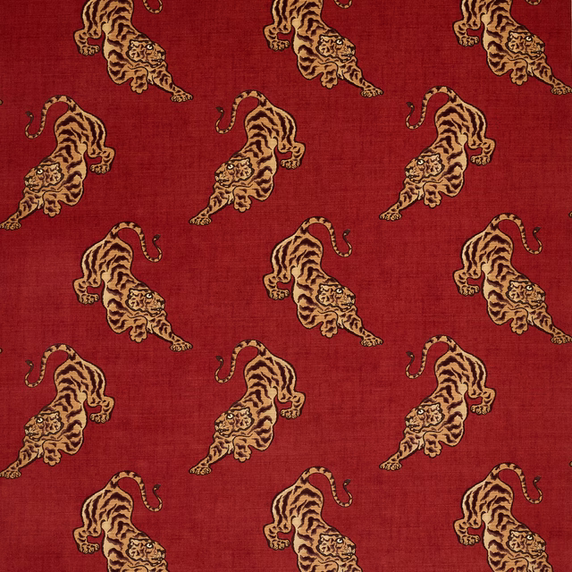 Red fabric swatch with repeating beige tiger motifs and a soft textured surface