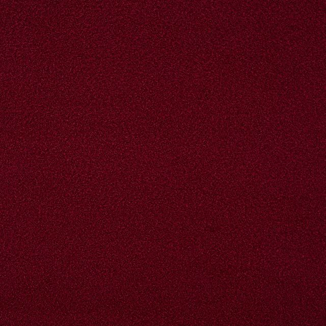 Deep ruby red textured fabric swatch with a fine speckled weave