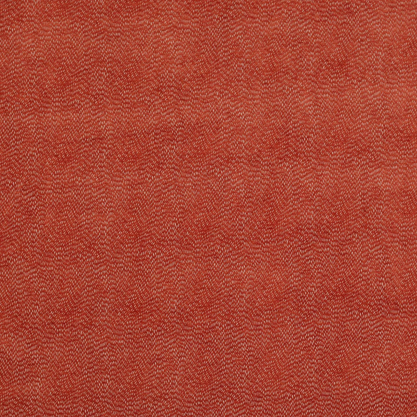 Close-up of a warm copper terracotta woven fabric with fine speckled texture