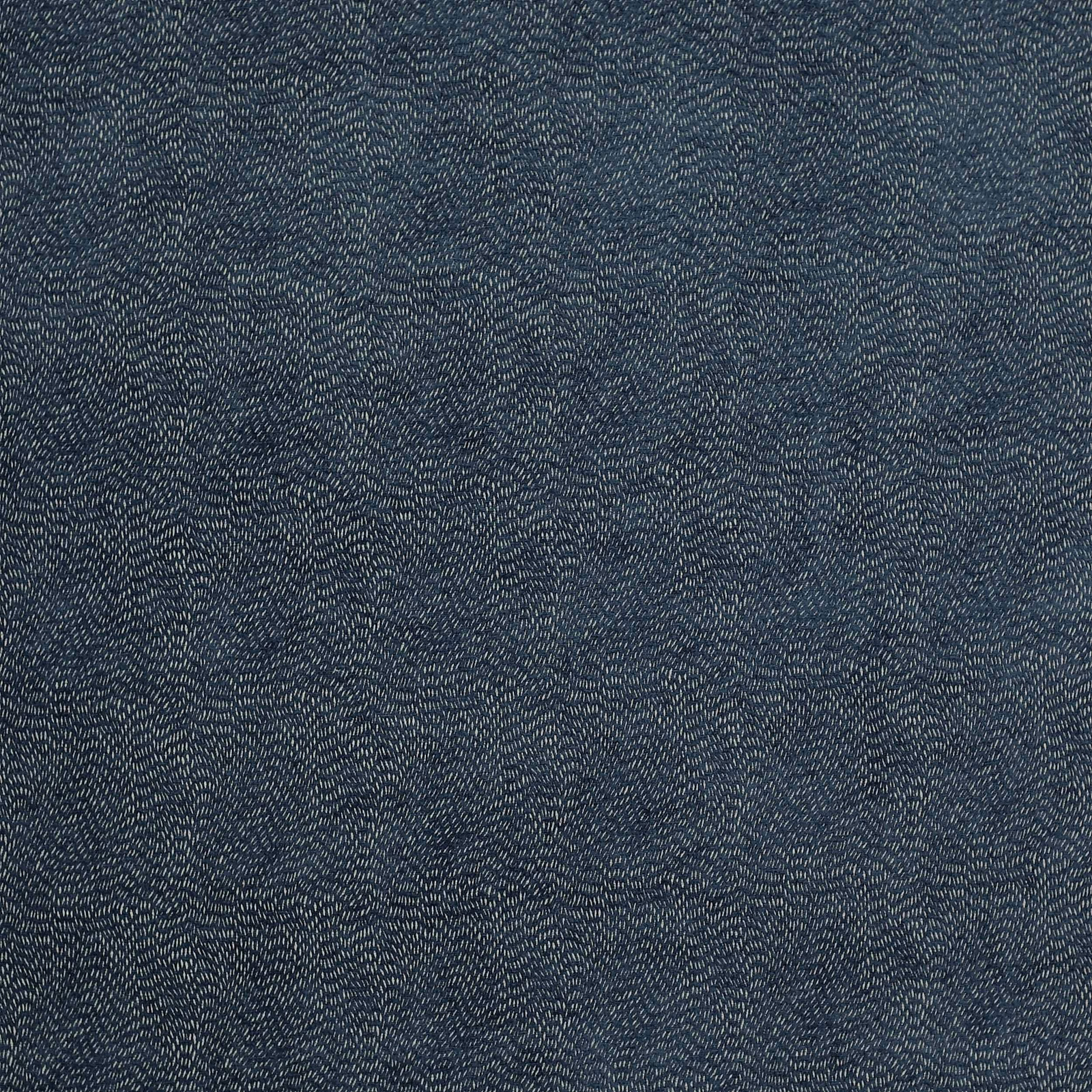 Deep indigo woven fabric with fine pale speckling and textured surface