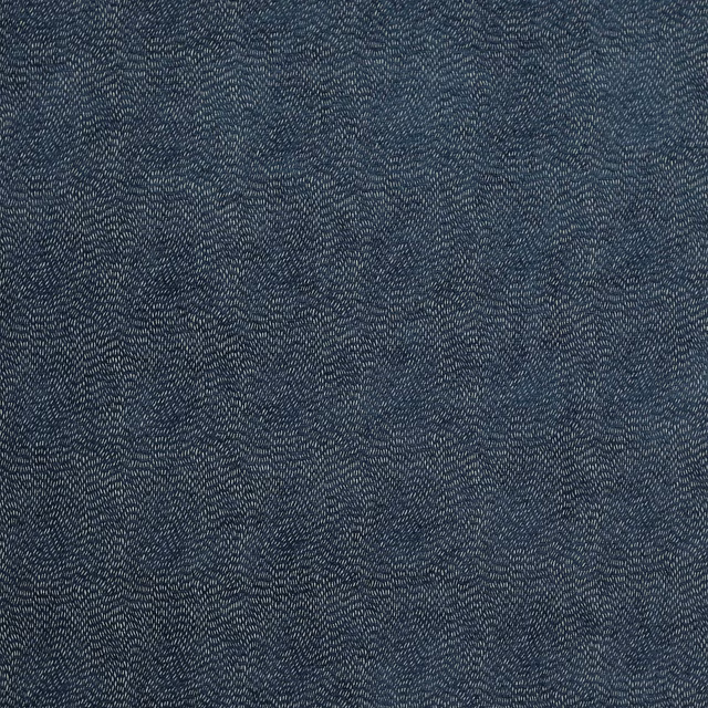 Deep indigo woven fabric with fine pale speckling and textured surface