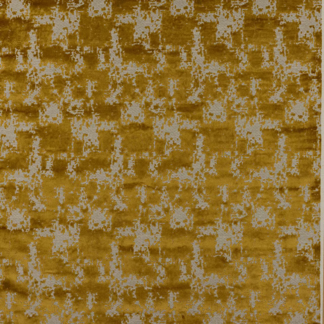 Golden ochre woven fabric with pale distressed geometric motif