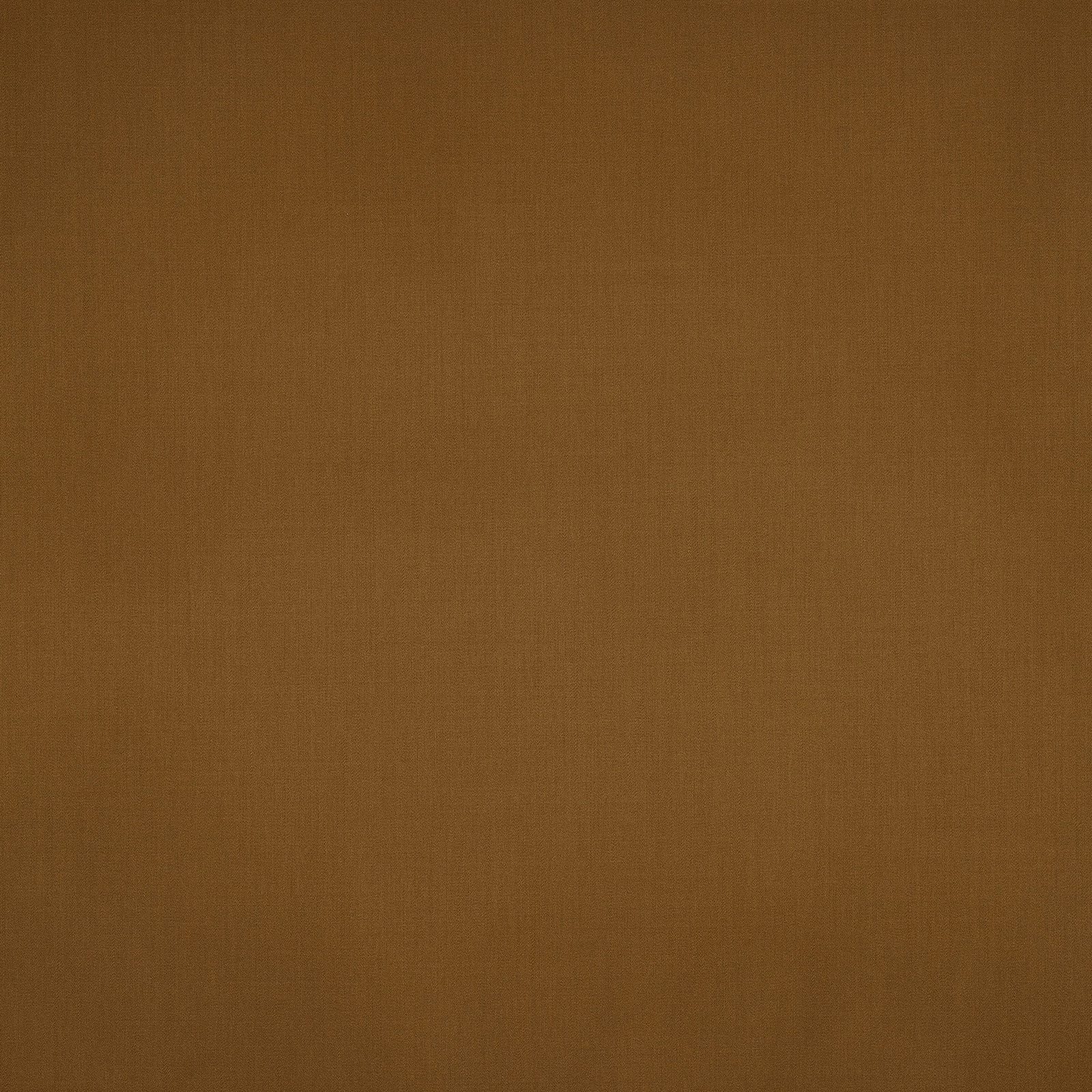 Close-up of plain warm nutmeg-brown wool fabric with a fine matte weave
