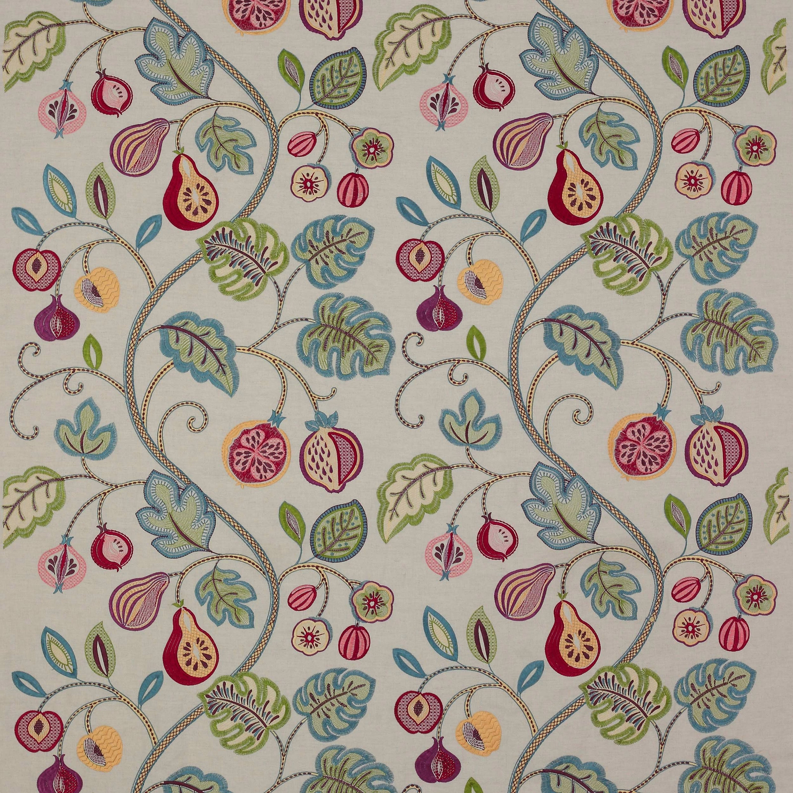 Cream embroidered fabric with curling vines, leaves and fruit motifs in blue, green, pink and plum
