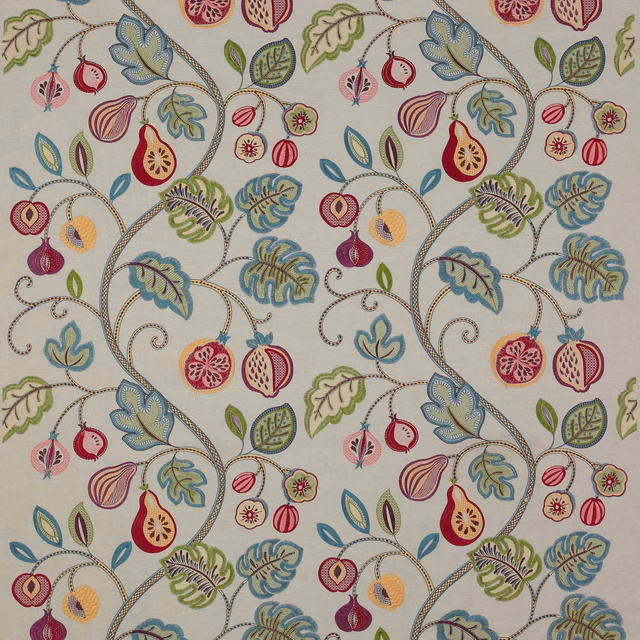 Cream embroidered fabric with curling vines, leaves and fruit motifs in blue, green, pink and plum