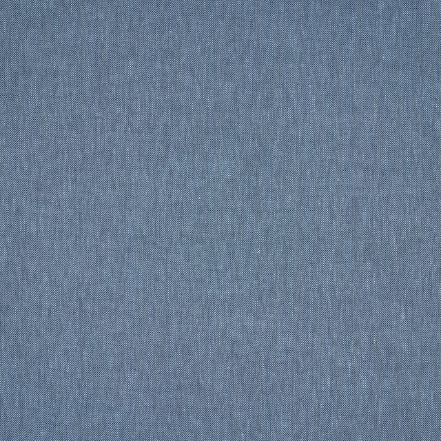 Close-up of soft denim blue linen fabric with fine herringbone texture
