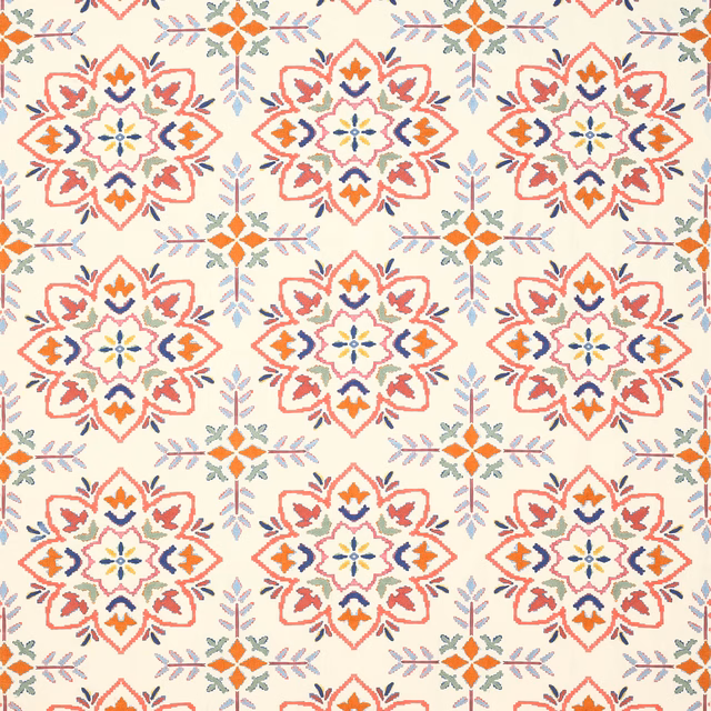 Cream fabric swatch with coral-red medallions and small blue, orange and sage motifs